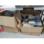 Four boxes of assorted books to include paperbacks by Dan Brown, complete book of home