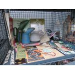 A cage of items, to include: BSA books, maintenance manuals, motorbike photographs and head lamps