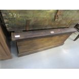 A dark wood stained blanket box