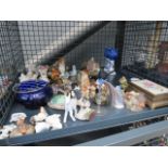 A cage of assorted bird, rabbit and dog figurines