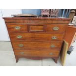 A mahogany three over three chest of drawers with brass escutcheons