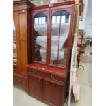 A modern glazed two door over three drawer display cabinet