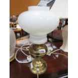 Table lamp in the form of a paraffin lamp with white opaque shade