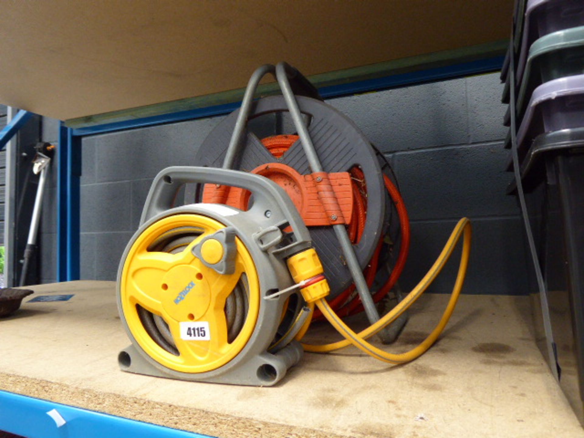 Two hose pipes and hose reels with water