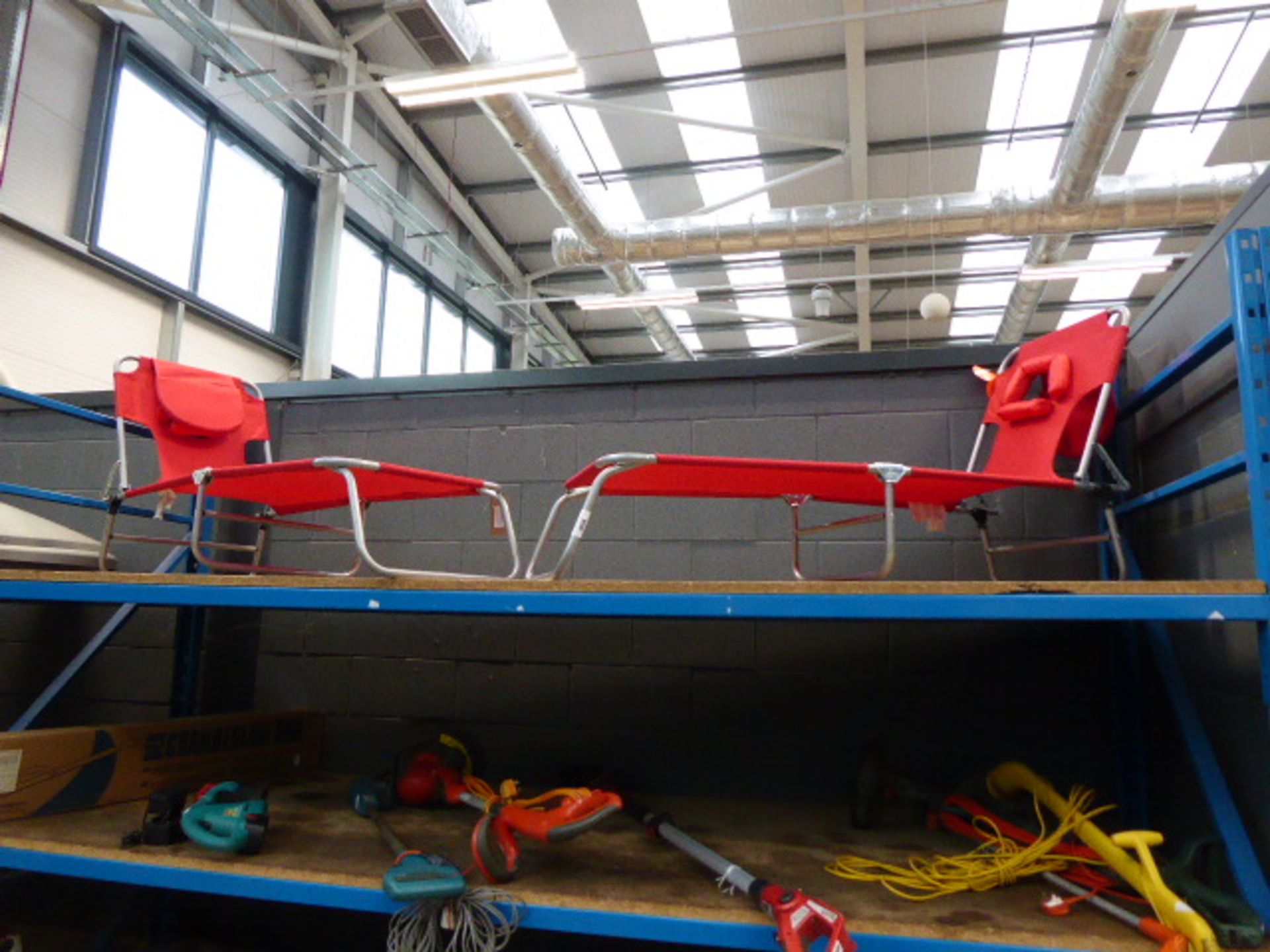 Pair of red cloth and aluminium folding sun loungers