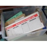 A box containing vinyl records, toy rocker carrying case, water jug and books