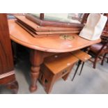 An oval oak extending dining table