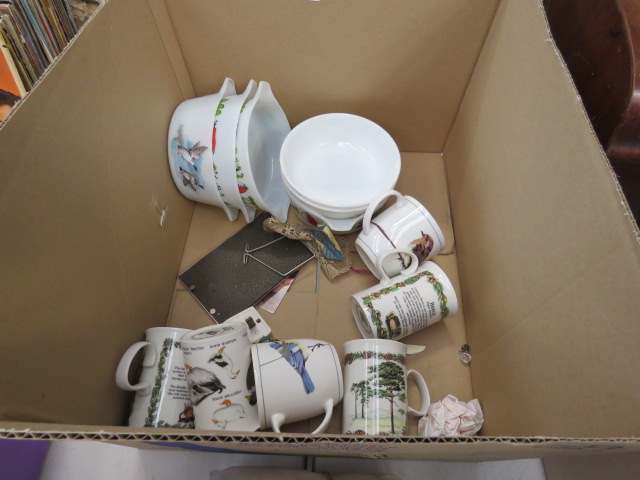 A box containing coffee mugs and various dishes