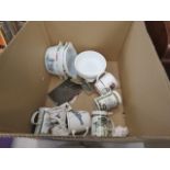 A box containing coffee mugs and various dishes