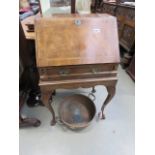 A reproduction mahogany bureau on cabriole supports