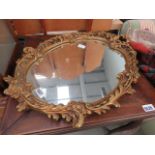 Oval mirror in ornate gilt frame