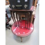 A reproduction mahogany circular coffee table, plus a matching nest of three tables