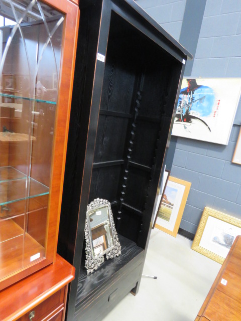 A black painted open fronted bookcase, with drawer under (AF)