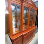 A reproduction yew glazed break front display cabinet, with cupboard base under