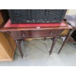 Dark wood occasional table with red leather insert and ceramic wheels