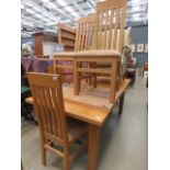 An oak extending dining table, plus six chairs