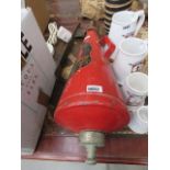 A vintage Minimax fire extinguisher with wall brackets