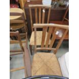 Pair of lined oak dining chairs with rush seats