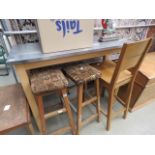 Stainless steel topped kitchen counter with single chair