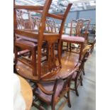 A reproduction mahogany extending dining table, plus eight chairs to include two carvers