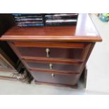 A dark wood three drawer storage cabinet