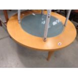 A circular beech coffee table with glazed insert
