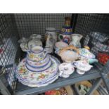 A cage containing a quantity of floral pattern Italian crockery
