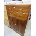 A dark wood tallboy with cupboard under