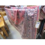 (18) A large pink Afghan carpet, 3.5 x 2.5m