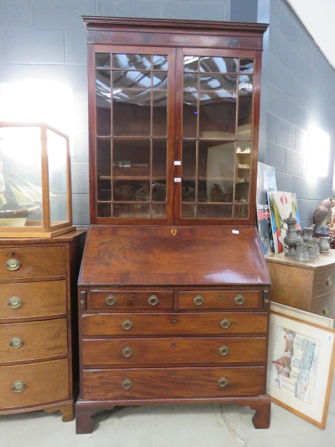 Dark wood bookcase over bureau