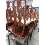 A dark wood extending dining table, plus eight chairs