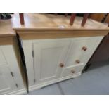A cream painted narrow oak sideboard, with cupboard and three drawers to the side