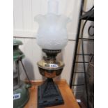 An oil lamp with brass reservoir