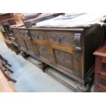 An oak sideboard with carved panels