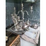 A quantity of silver plate, to include: serving trays, candlesticks and teapots