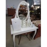 A white painted dressing table with oval mirror