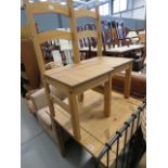 A square rustic pine table with two chairs