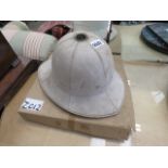 Pith helmet and a boxed drum