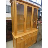 A glazed oak display cabinet, with base under