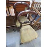 A pair of Victorian balloon back dining chairs