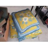A green and blue floral throw, plus a pair of matching cushions