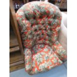 A floral patterned button back fabric armchair