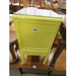 A yellow painted sewing box with drawer under
