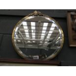 Circular bevelled mirror in brass frame