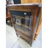 A glazed oak china cabinet