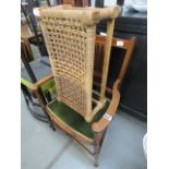 Dark wood bedroom chair with green upholstery and a woven footstool
