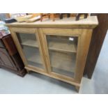 Stripped pine glazed 2 shelved cupboard