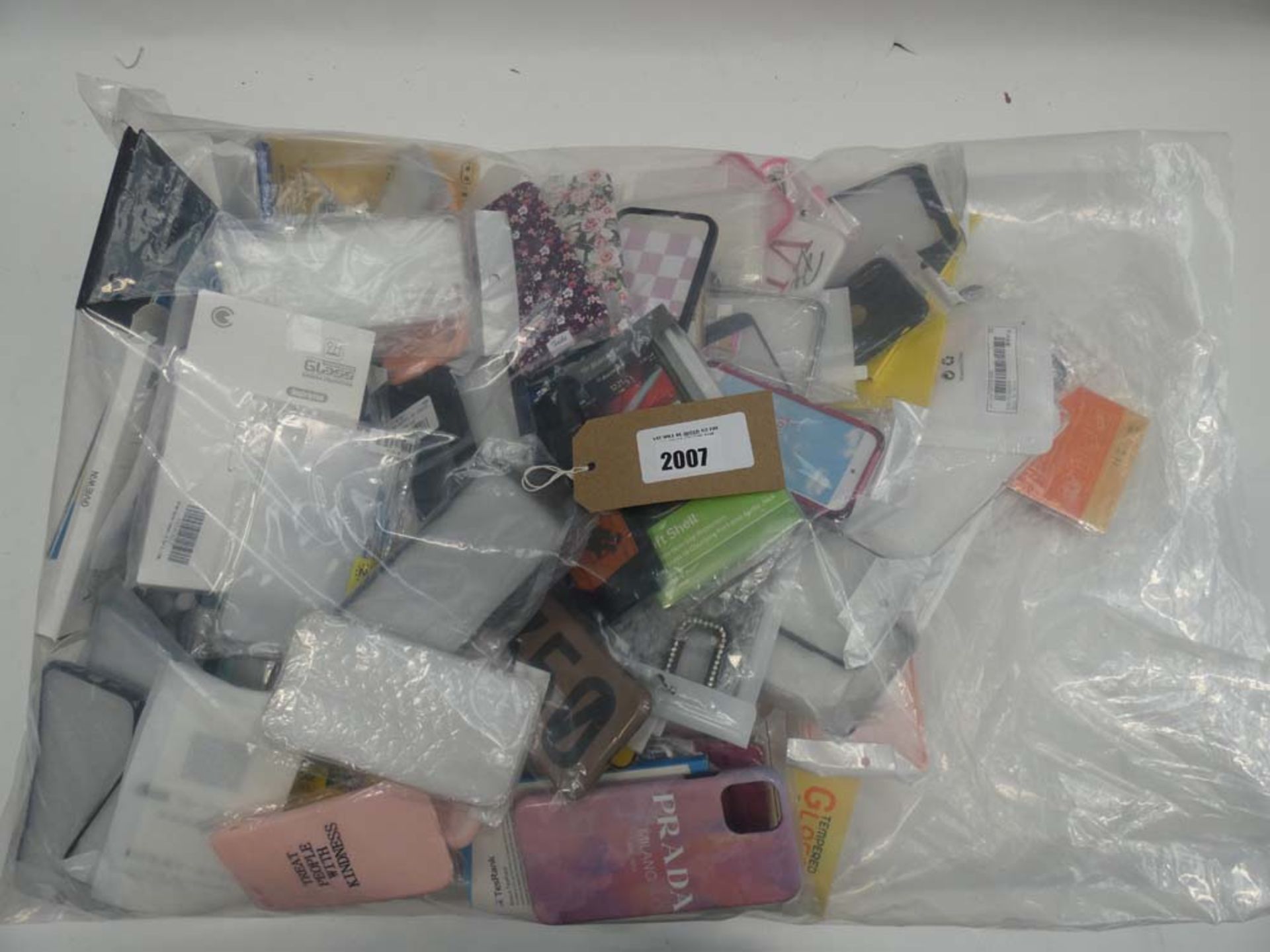 Bag containing quantity of various mobile phone cases and covers