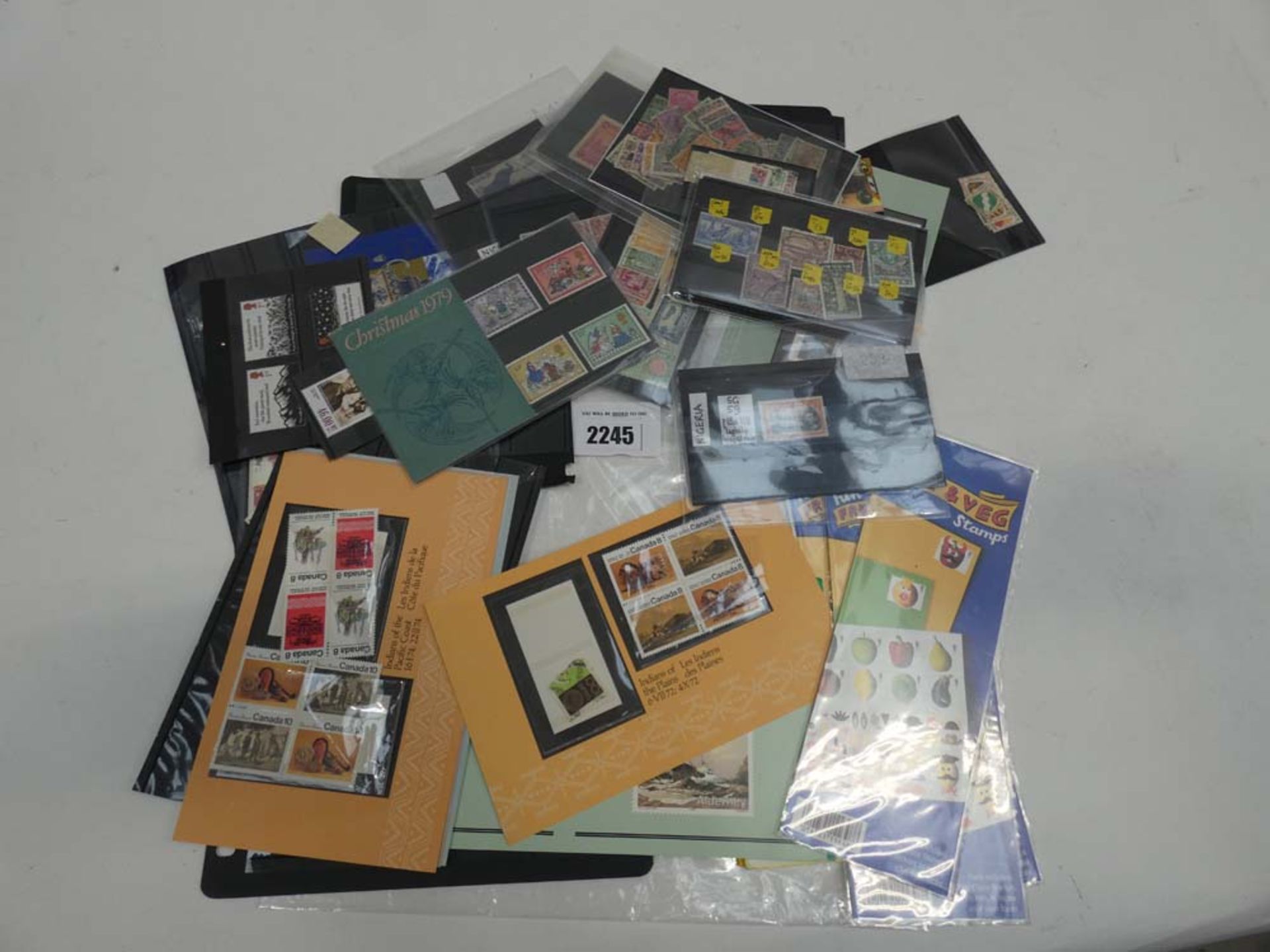 Quantity of used and unused stamps in mostly black stamp sheets