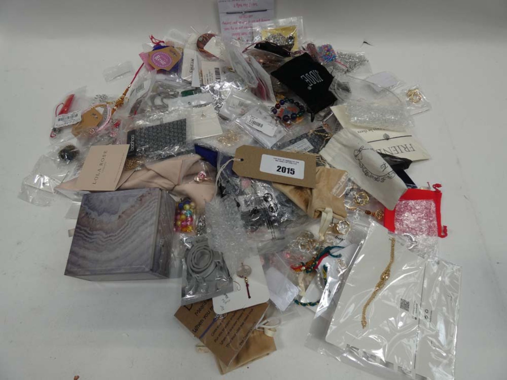 Bag containing quantity of loose costume and dress jewellery